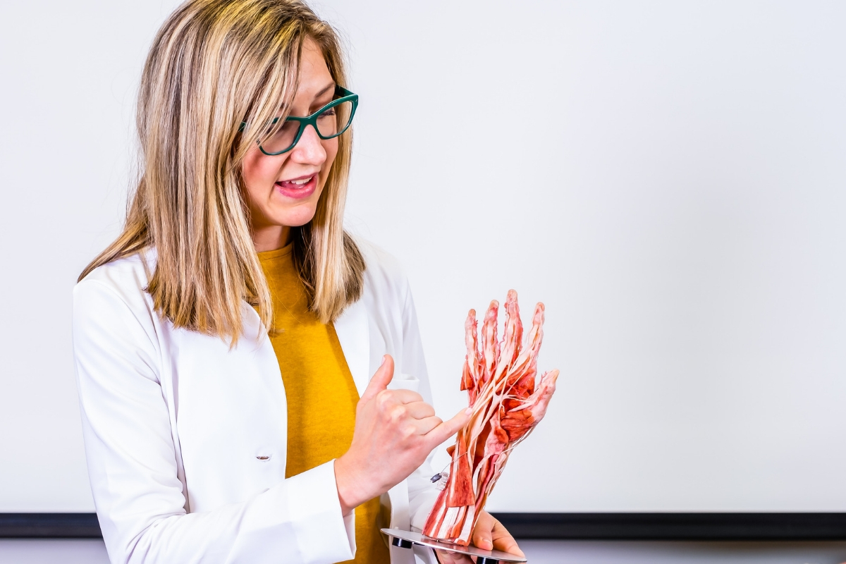 Jamie Decker points to plastinated hand specimen