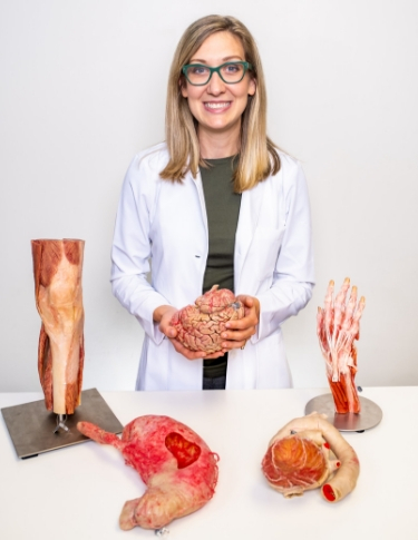 Jamie Decker, founder of Experience Anatomy, holding plastinated organs
